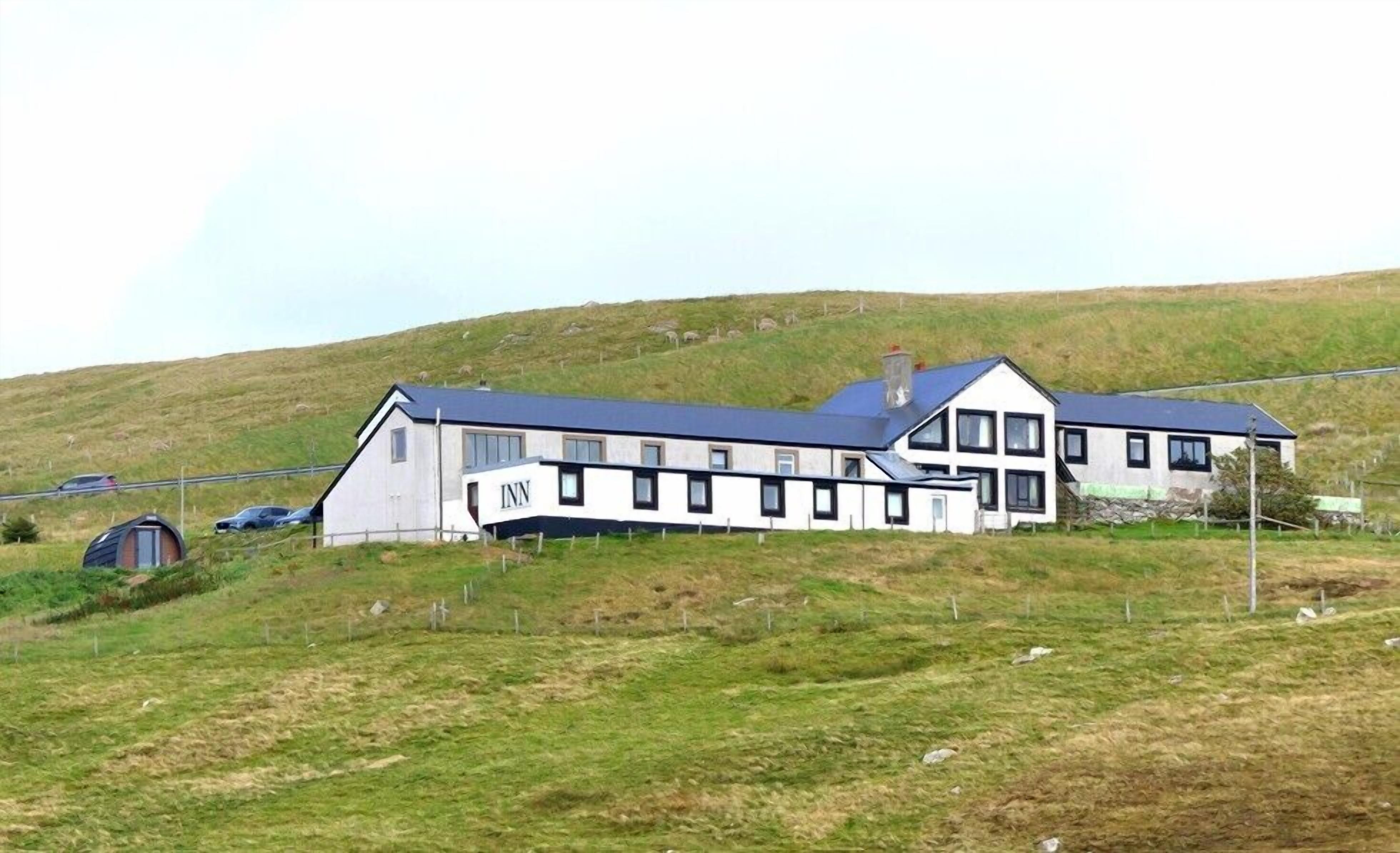 A large, modern hotel with multiple rooms and a prominent 'INN' sign.