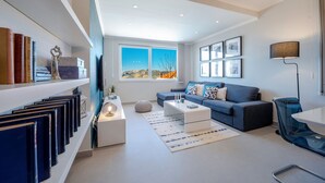 A modern living room with a sofa, coffee table, and bookshelves. - Villa Lucia (dubrovnik)