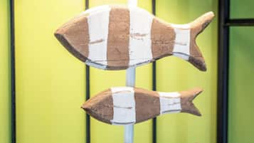 A lamp with a fish-shaped base and a textured lampshade.