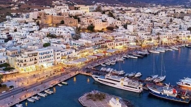 A coastal town with white buildings, a marina with boats, and a small island with a fountain. - Villa Sofia, The Best SeaView Of Naxos (Νάξος)