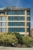 A modern building with a sign reading "Pierre & Vacances". It features multiple floors with large windows and a mix of dark and light facade panels.