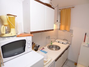 Fridge, dishwasher, coffee/tea maker, cookware/dishes/utensils