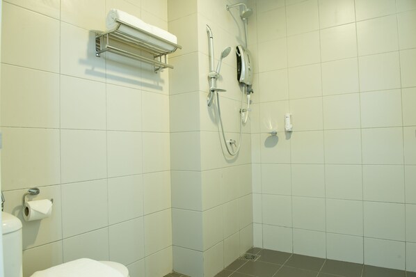 A bathroom with a toilet, a towel rack, a shower with a handheld showerhead, and a wall-mounted towel warmer. - Ezzyhome Medini (Iskandar Puteri)