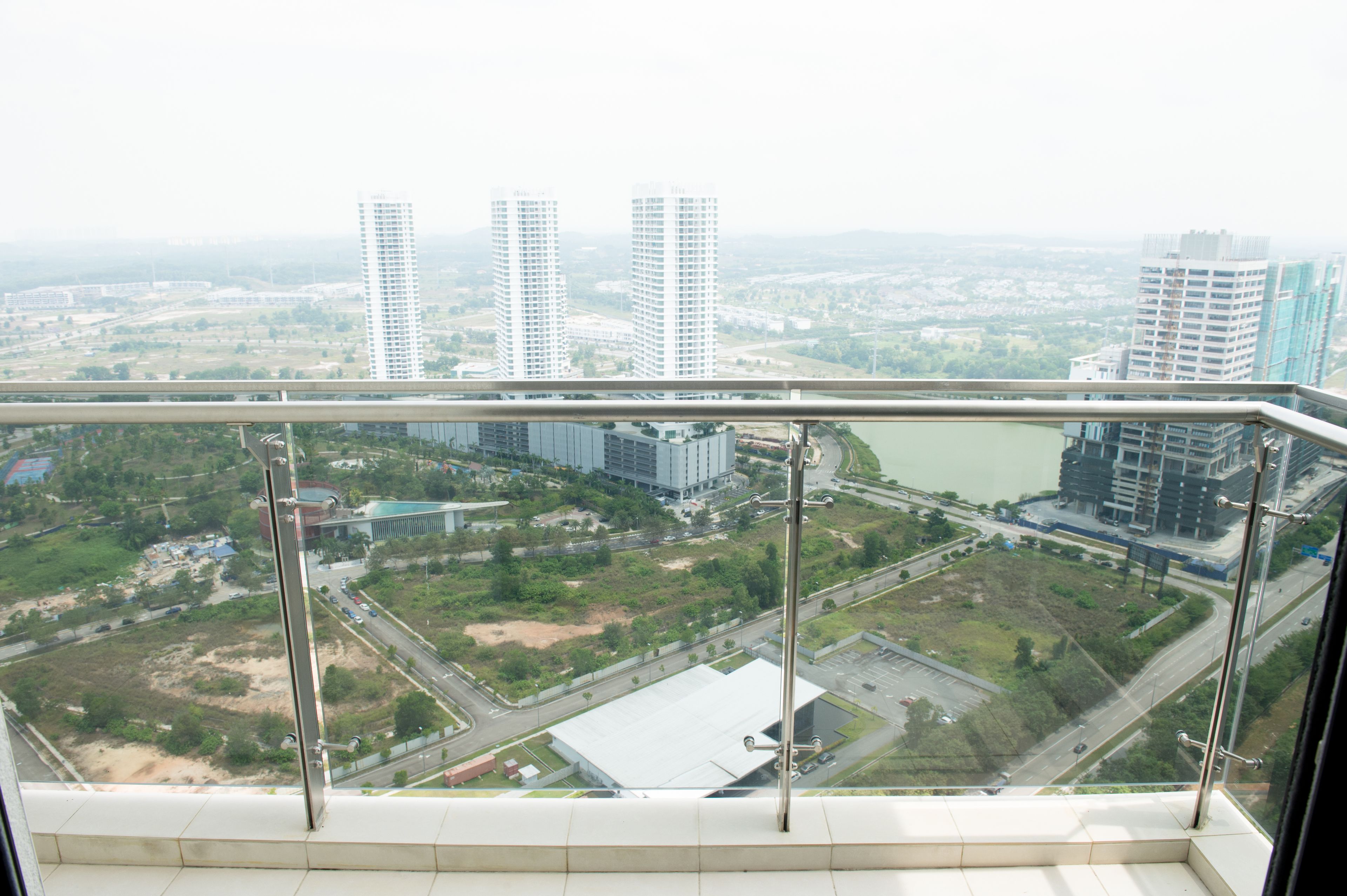 A high-rise building with a view of a cityscape, including several tall buildings and a river.
