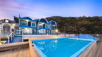 Seasonal outdoor pool, open 11:00 AM to 7:00 PM, pool umbrellas