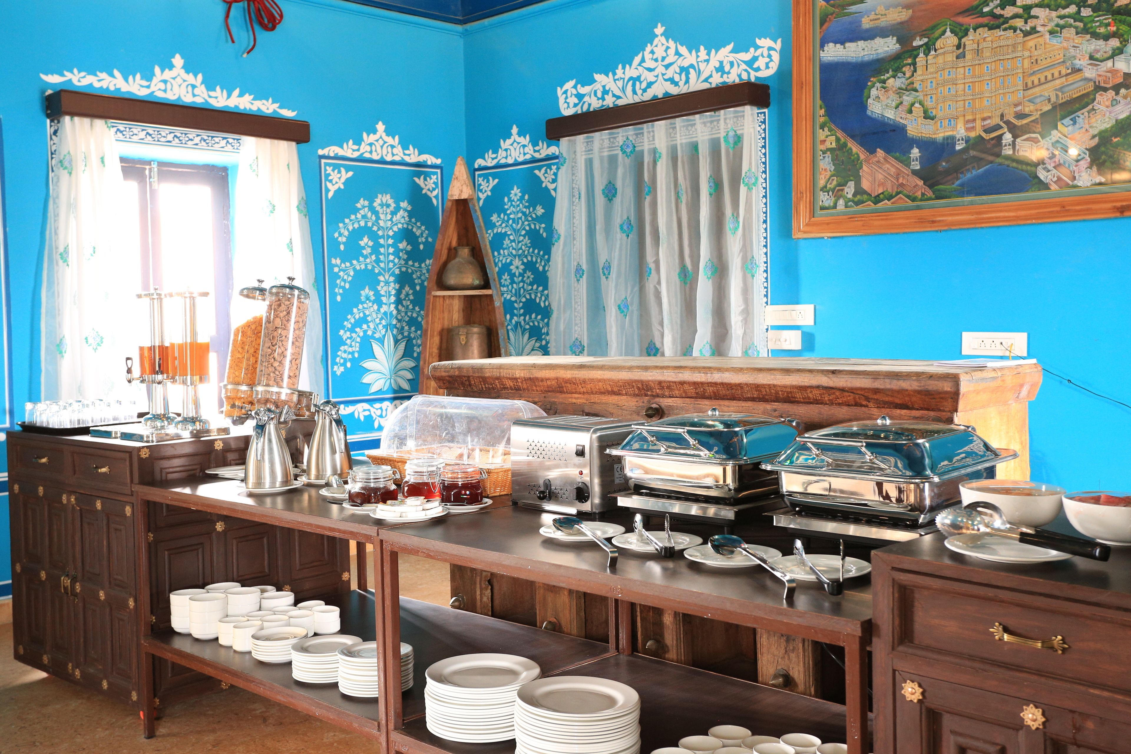 A breakfast buffet setup with various food items and utensils.