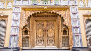 A detailed entrance with ornate carvings and a large, central door.