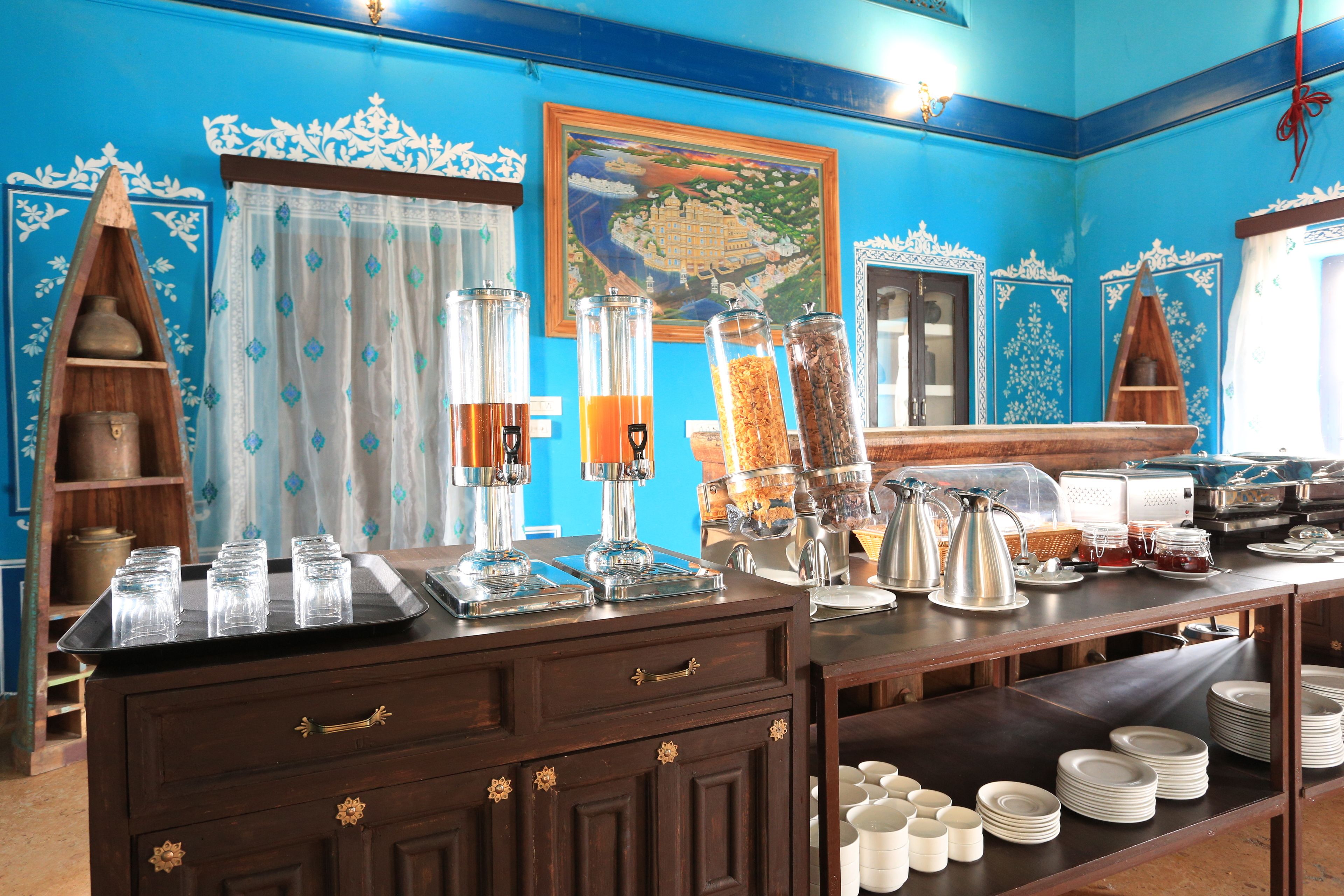 A breakfast buffet setup with various food items and beverages.