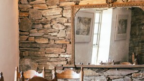 A restaurant with stone walls, wooden tables, and chairs. - Corcreggan Mill (Dunfanaghy)