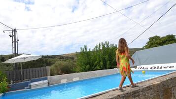 Relax by the pool at Villa Olive, where a refreshing dip awaits.