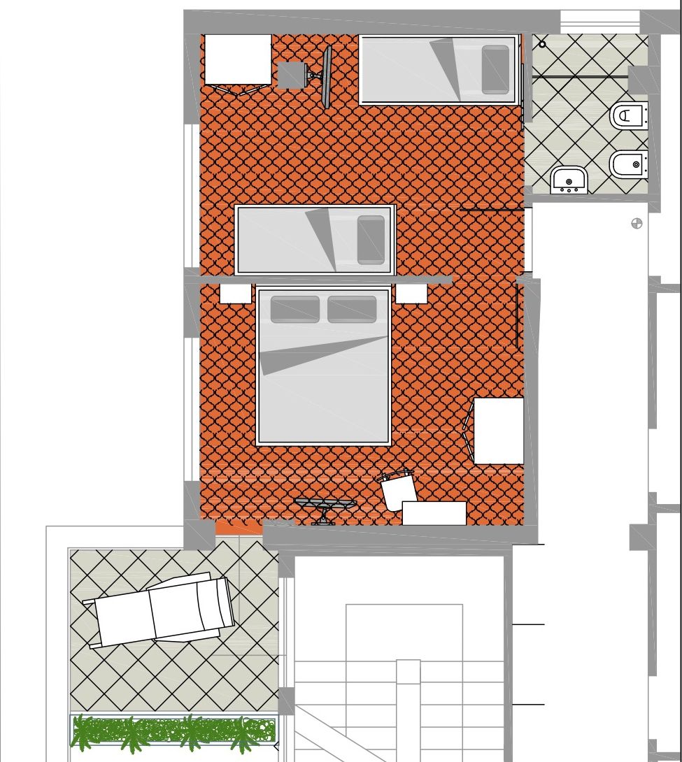 Plano de planta que muestra una zona de cocina, un comedor y una pequeña área de estar al aire libre.