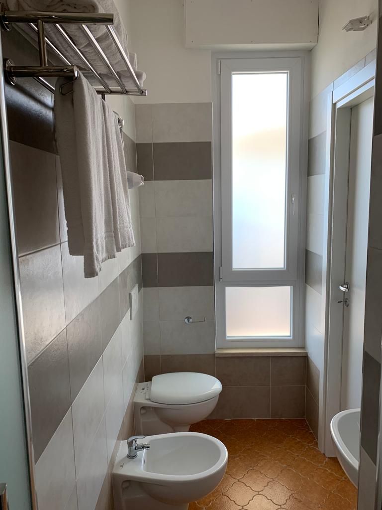 Un bany compacte amb vàter, bidet i una finestra que deixa entrar llum natural.