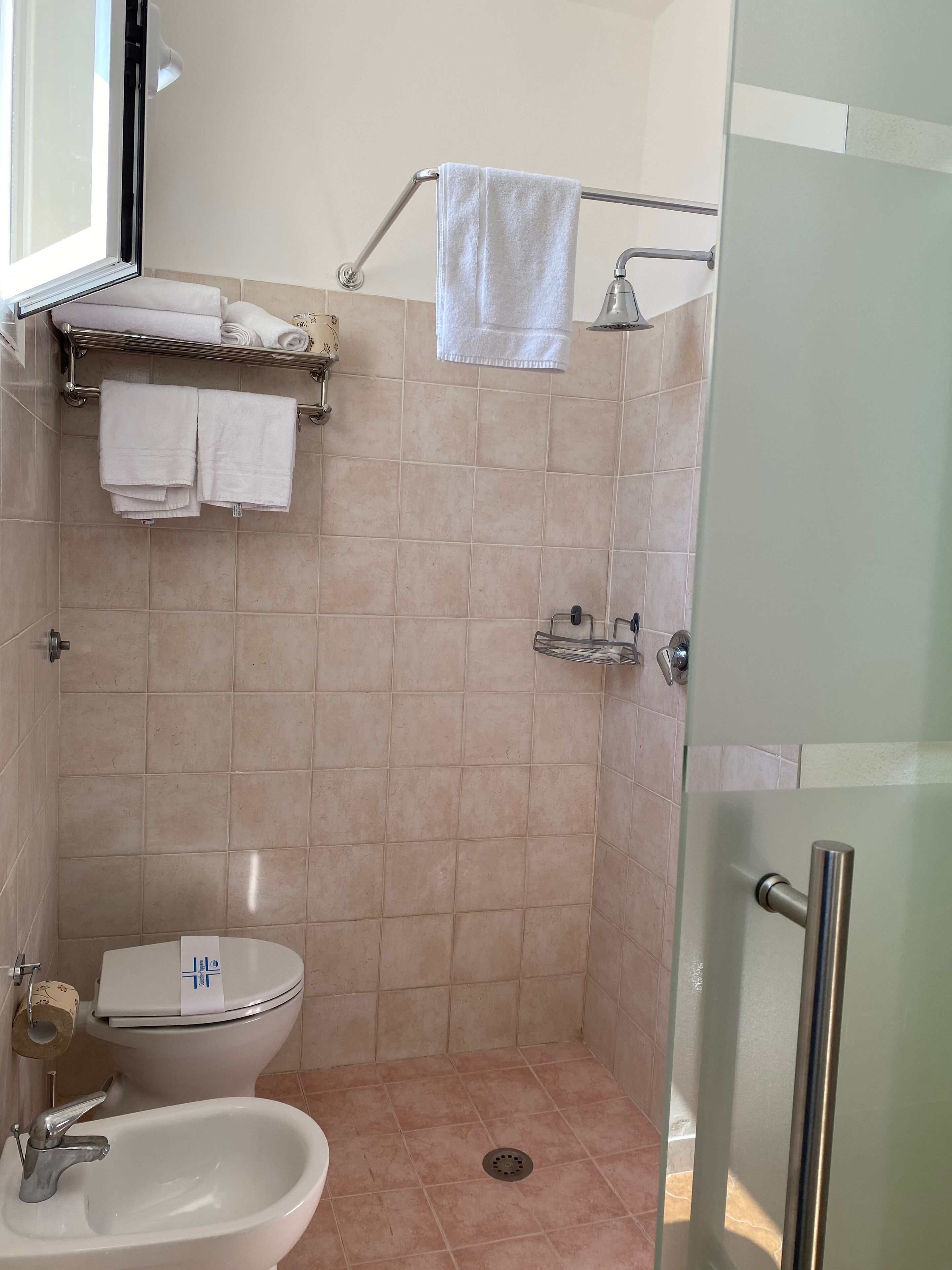 A bathroom with a toilet, bidet, and sink.