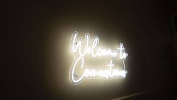 A neon sign with the words 'Welcome to Cornerstone.'