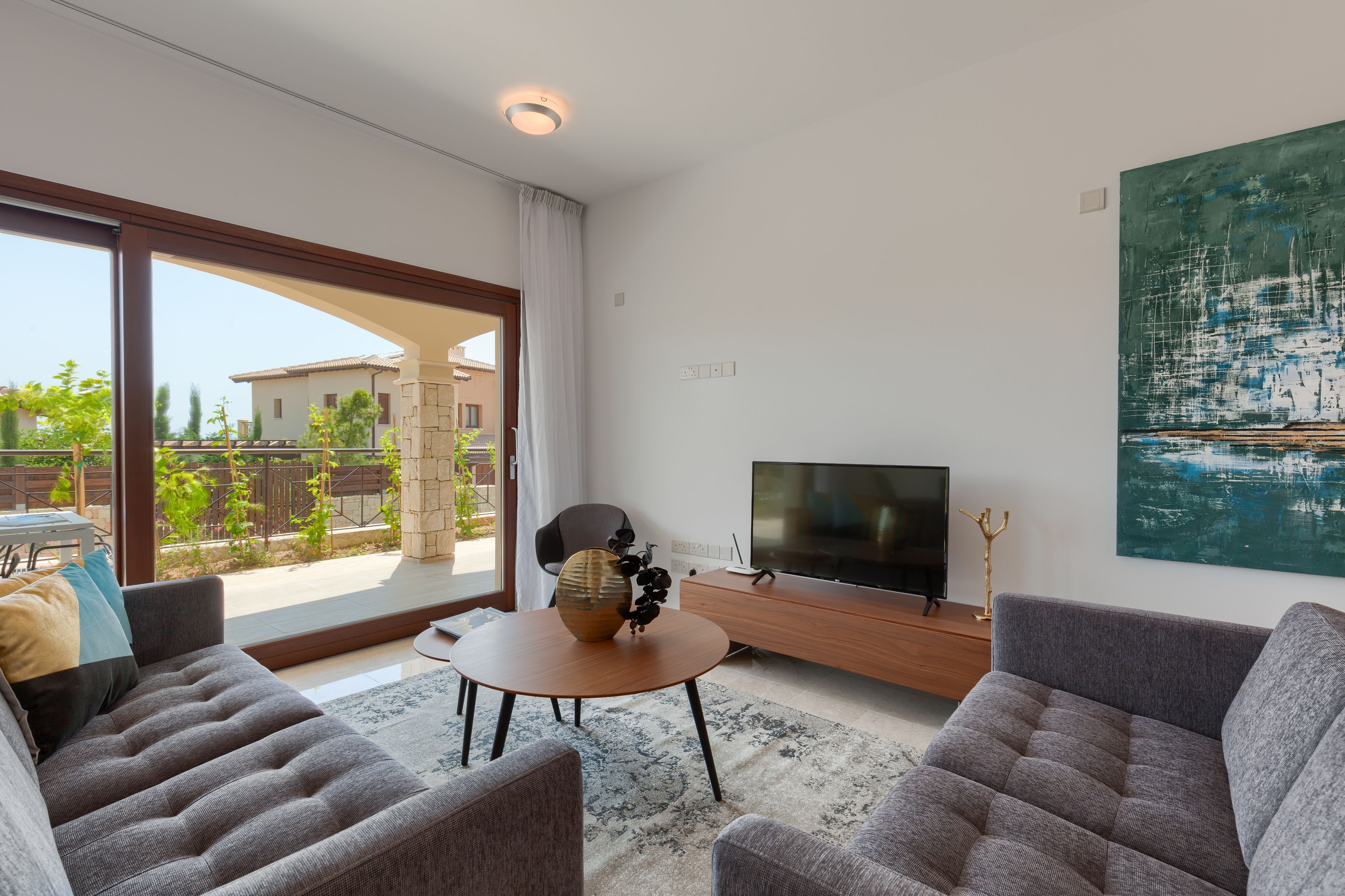 A modern living room with a sofa, coffee table, and TV.