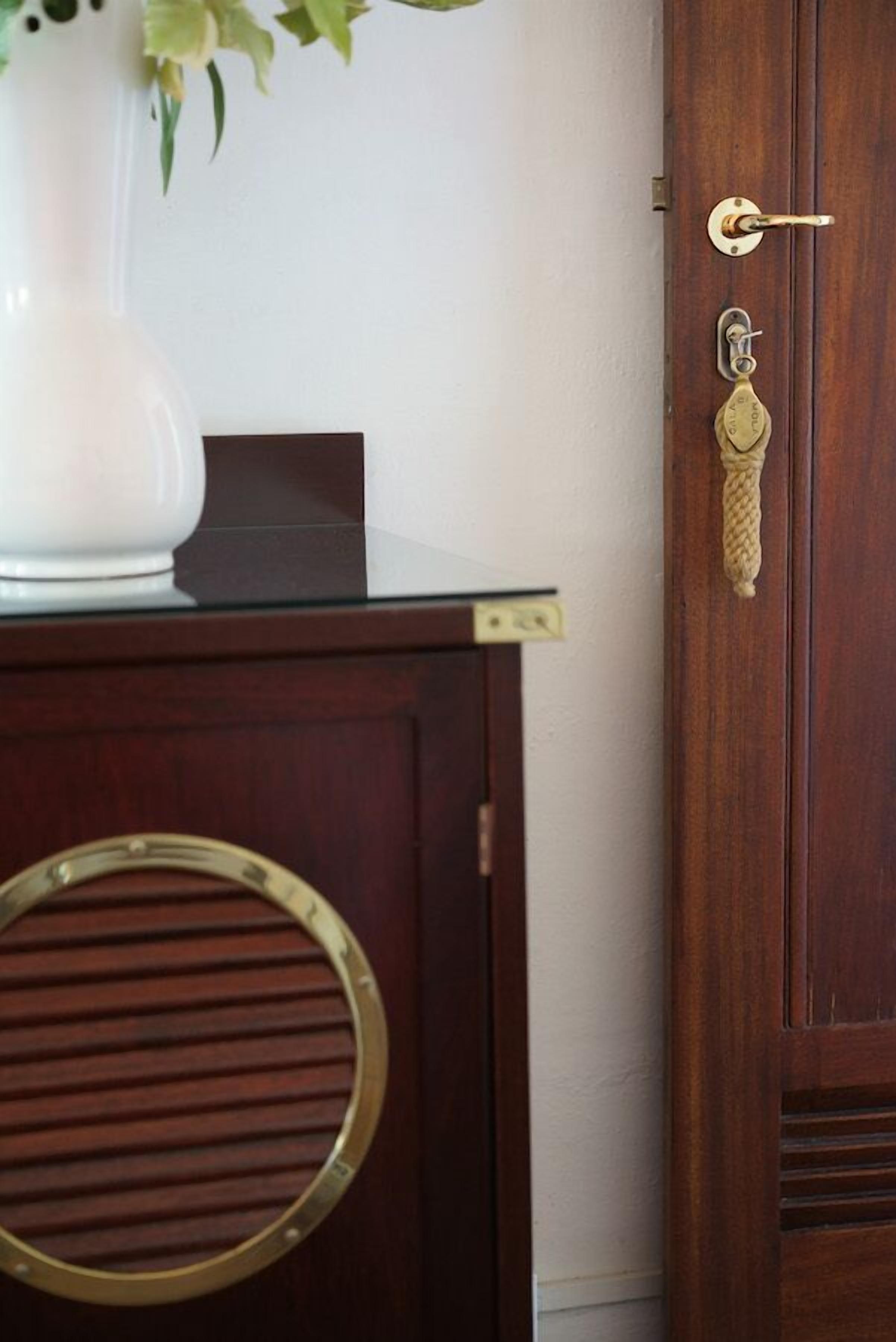 A wooden door with a brass handle, a keyhole, and a keyring.