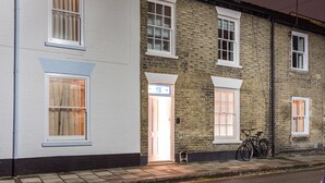A row of terraced houses with white and brick facades, a visible door, and a bicycle parked outside. - The Modern Classic - Contemporary & Elegant 3bdr Home (Cambridge)