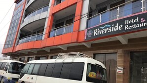 A Riverside Hotel & Restaurant with a white van parked in front. - Hotel River side and Restaurant (Swat)