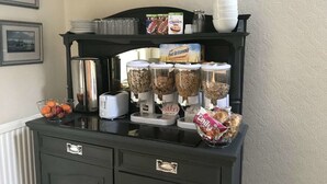 A buffet setup with various food items and condiments. - Manor View Guest House (Whitby)