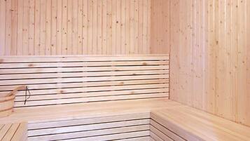A sauna with wooden benches and slatted walls.