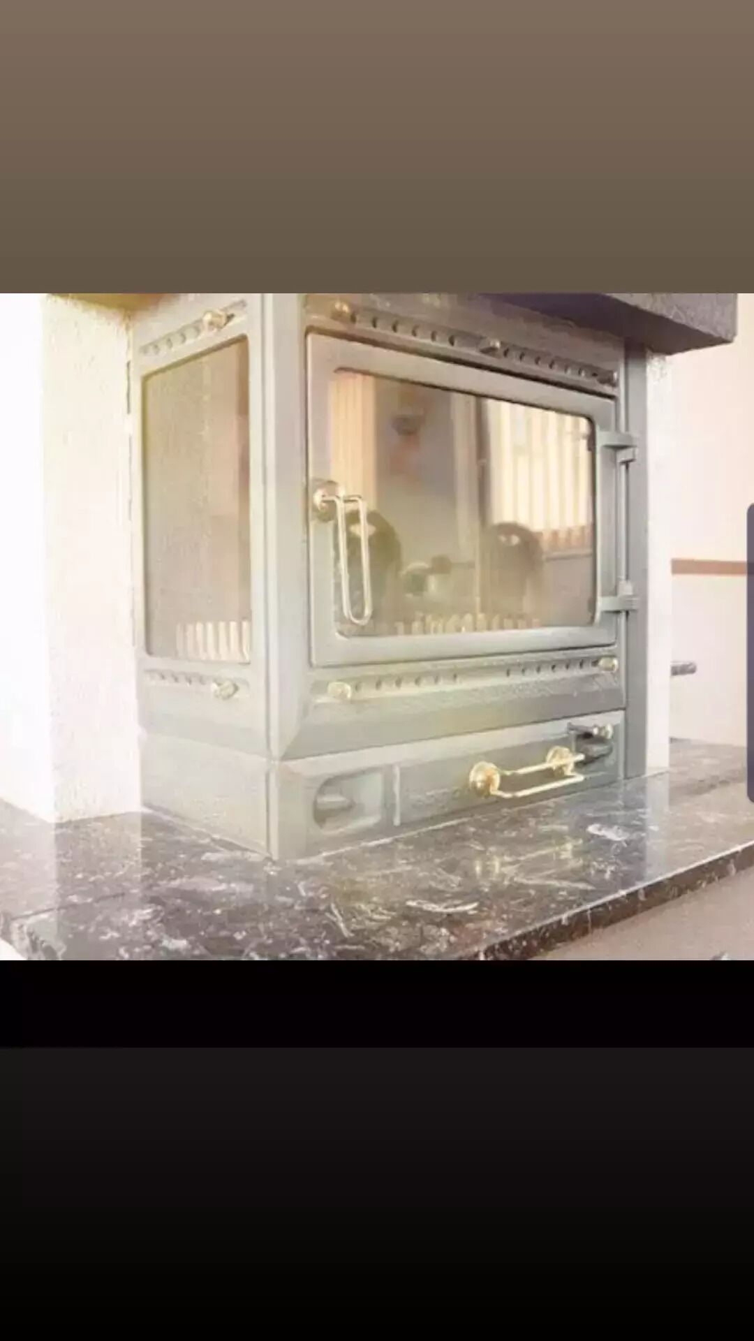 A kitchen stove with a glass door and a metal handle.