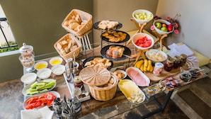 A buffet table with various food items and condiments. - Sunshine Boutique Hotel (Hersonissos)