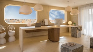 A modern kitchen with a large island, pendant lights, and a view of the sky through large windows. - Sunshine Boutique Hotel (Hersonissos)