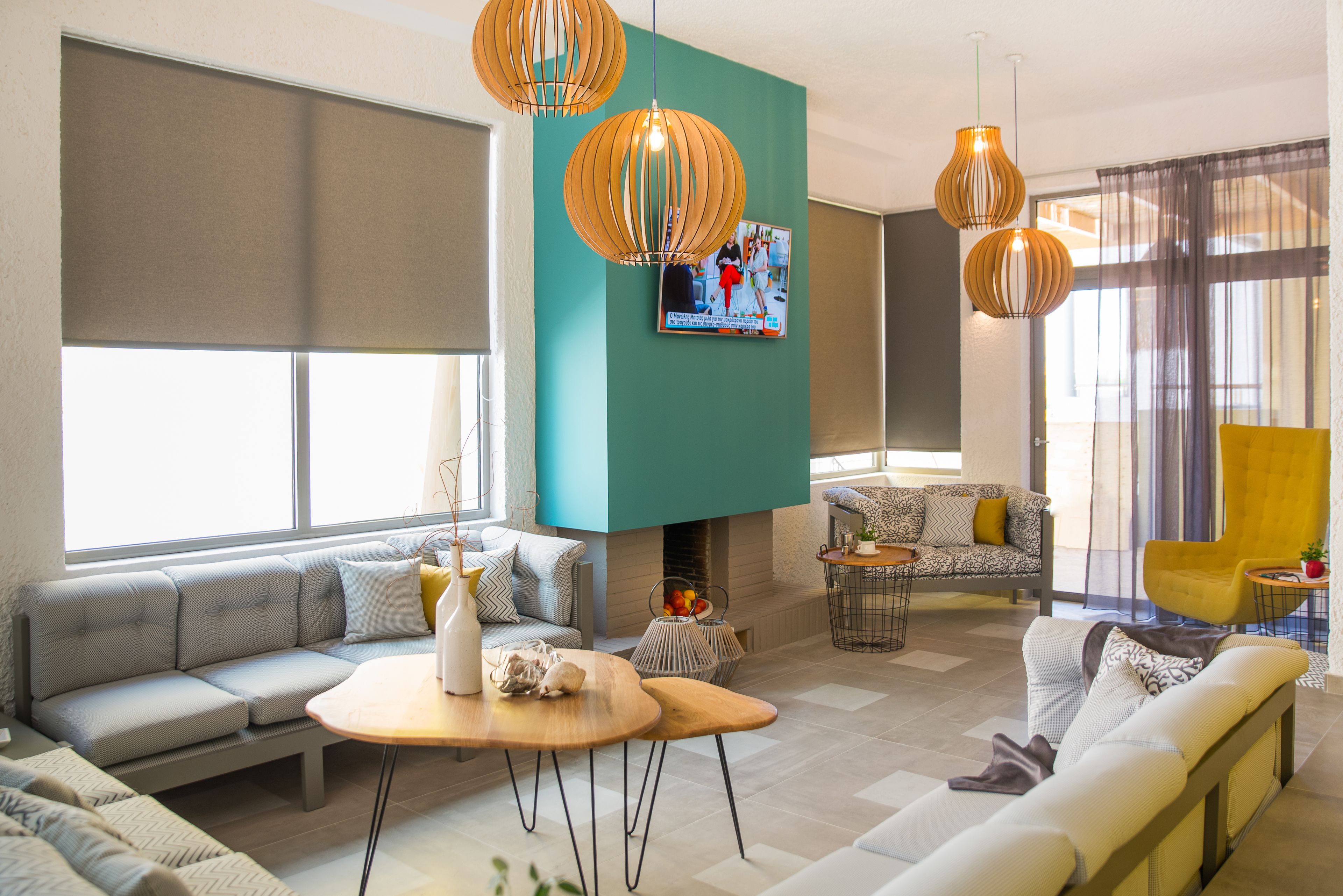 A modern living room with a sectional sofa, a small coffee table, and a fireplace.