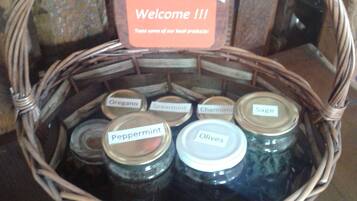 A wicker basket with jars labeled with various herbs and spices, and a welcome sign.