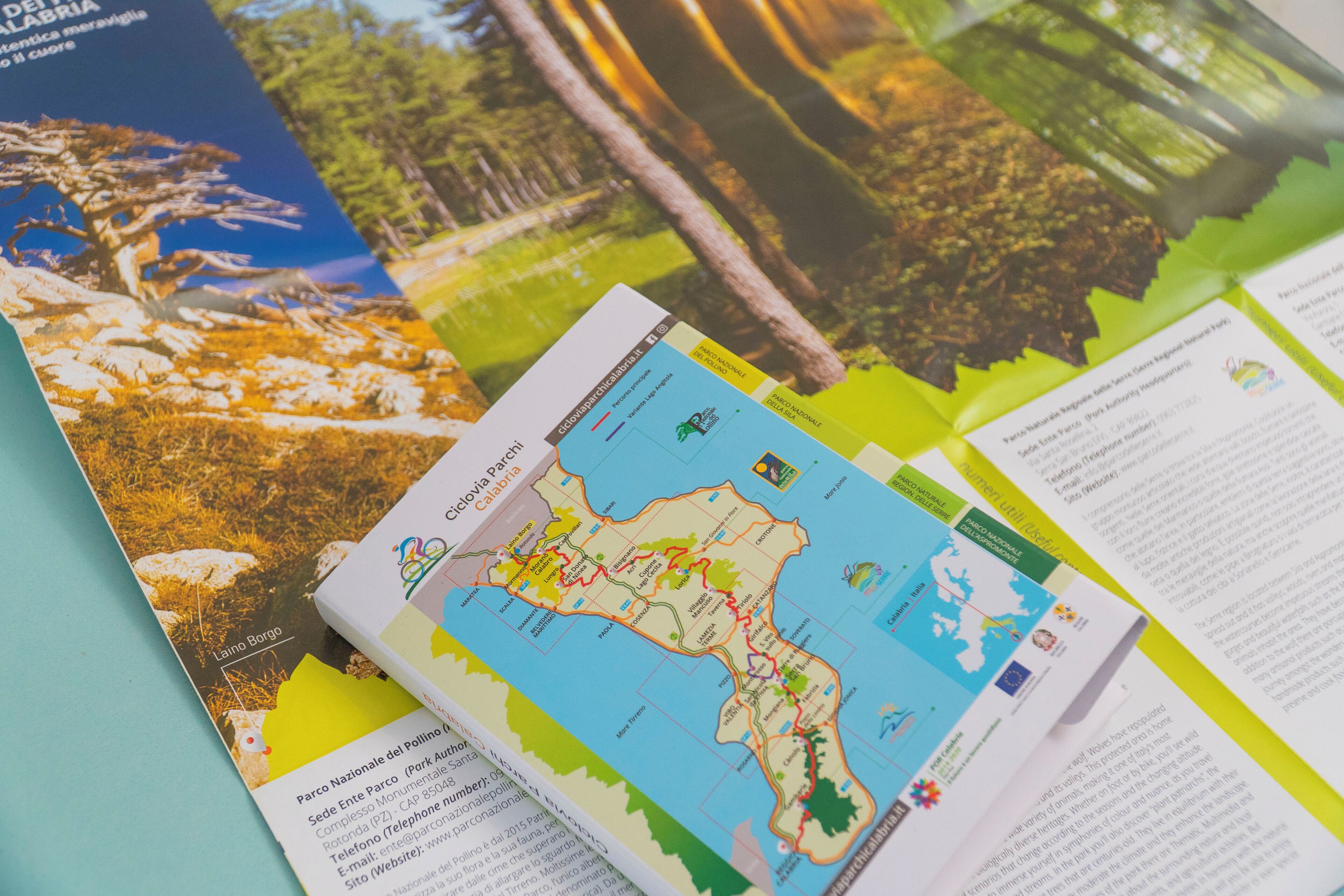 A map with labeled regions and a brochure with text and images of a natural landscape.