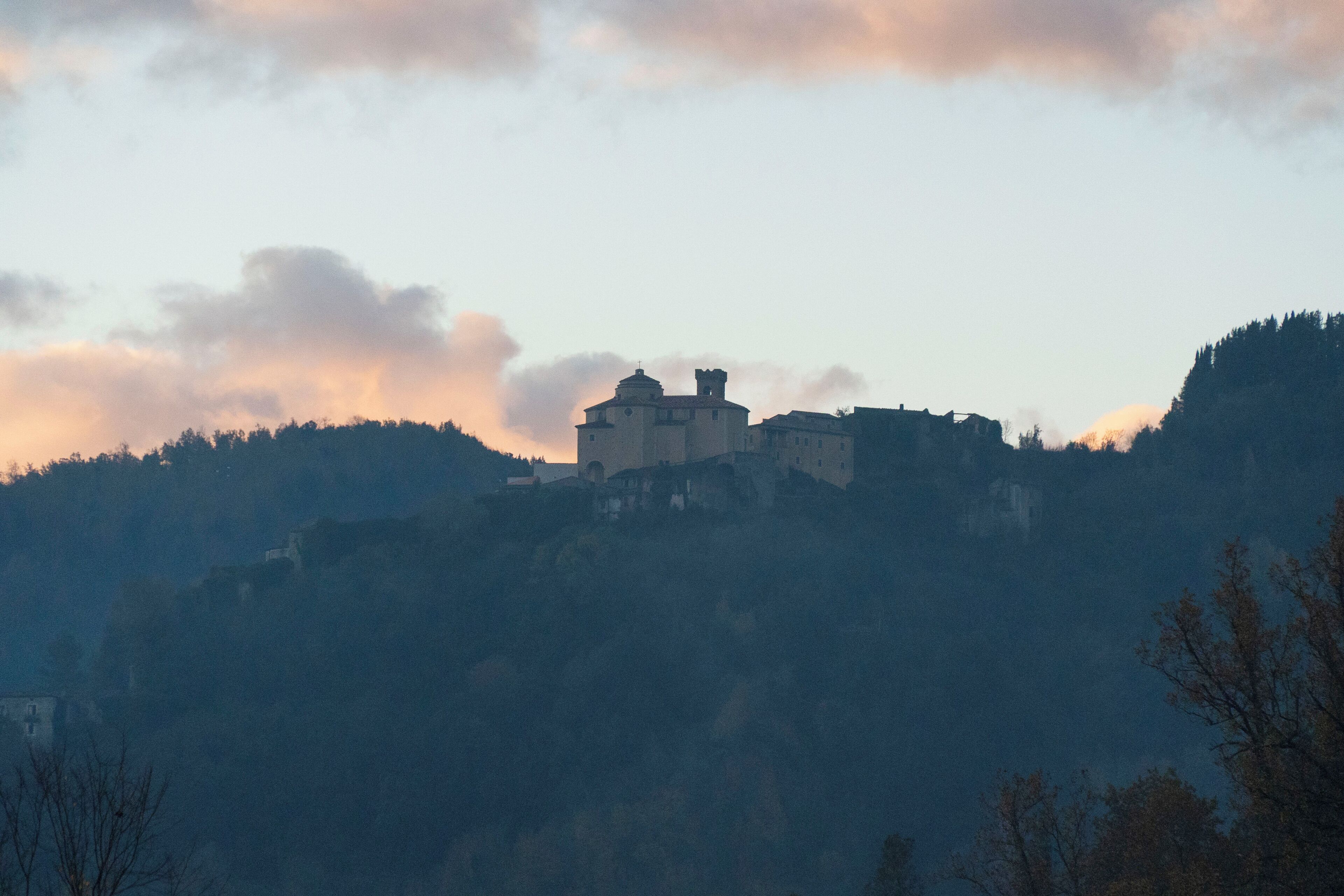 A historic building on a hill with a clear sky.
