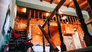 A wooden staircase with a red chair and a fire extinguisher. - Under the Clock Tower (Greek Traditional 125m² home) (Ναύπλιο)
