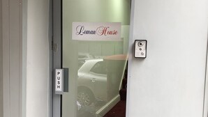 A door with a 'CCTV in operation' sign, a 'PUSH' sign, and a 'Leman House' sign. - Leman House (London)