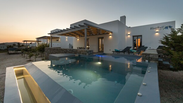 A modern resort with a swimming pool, outdoor seating, and a covered patio area. - BLUEBELL VILLA SUNRISE (ΚΑΜΠΟΣ)