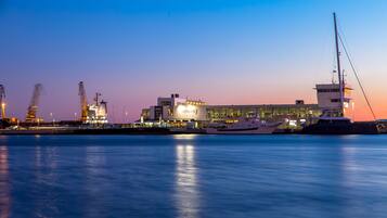 A waterfront industrial area with cranes, a large building labeled "Terminal 7", and a yacht docked nearby.