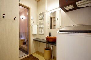 A compact bathroom with a sink, mirror, towel rack, and a trash bin. - 2bedrooms Kyomachiya Near Kyoto station-Max 9P (京都市)
