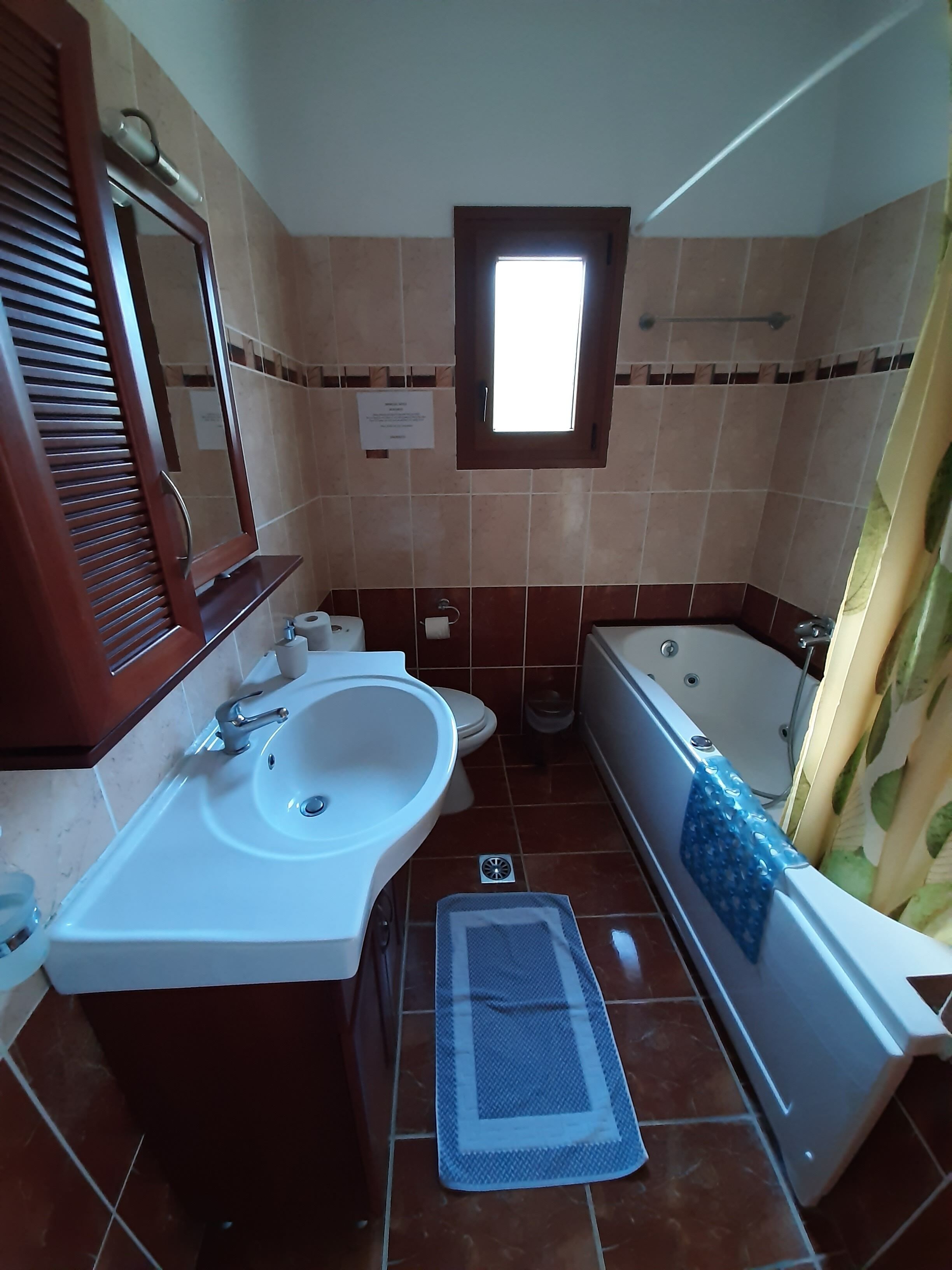 A bathroom with a sink, toilet, and bathtub.