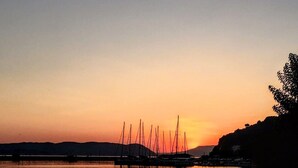 A sunset over a calm body of water with sailboats anchored in the distance. - Malena Pool Villa  with stunning view in a quiet location. Free WIFI and jacuz (Γλώσσα)