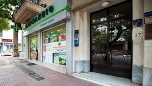 A storefront with a green and white sign, a large glass window, and a metal door with a number 37 plaque. - Attractive Flat near the Acropolis Museum - Athenian Homes, Athenian Homes (Athens)
