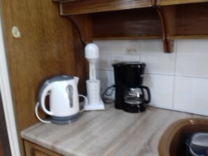 Fridge, microwave, coffee/tea maker, cookware/dishes/utensils