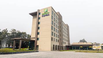 A Holiday Inn Express building with a modern design, featuring a flat roof and a large entrance area.
