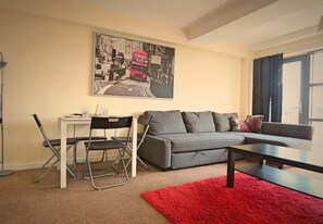 Departamento, vista a la ciudad | Área de sala de estar | Televisión de pantalla plana 