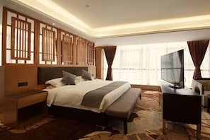 A modern hotel room with a large bed, a desk with a flat-screen TV, and a decorative wooden panel wall. - Days Inn by Wyndham Yongan (Sanming)