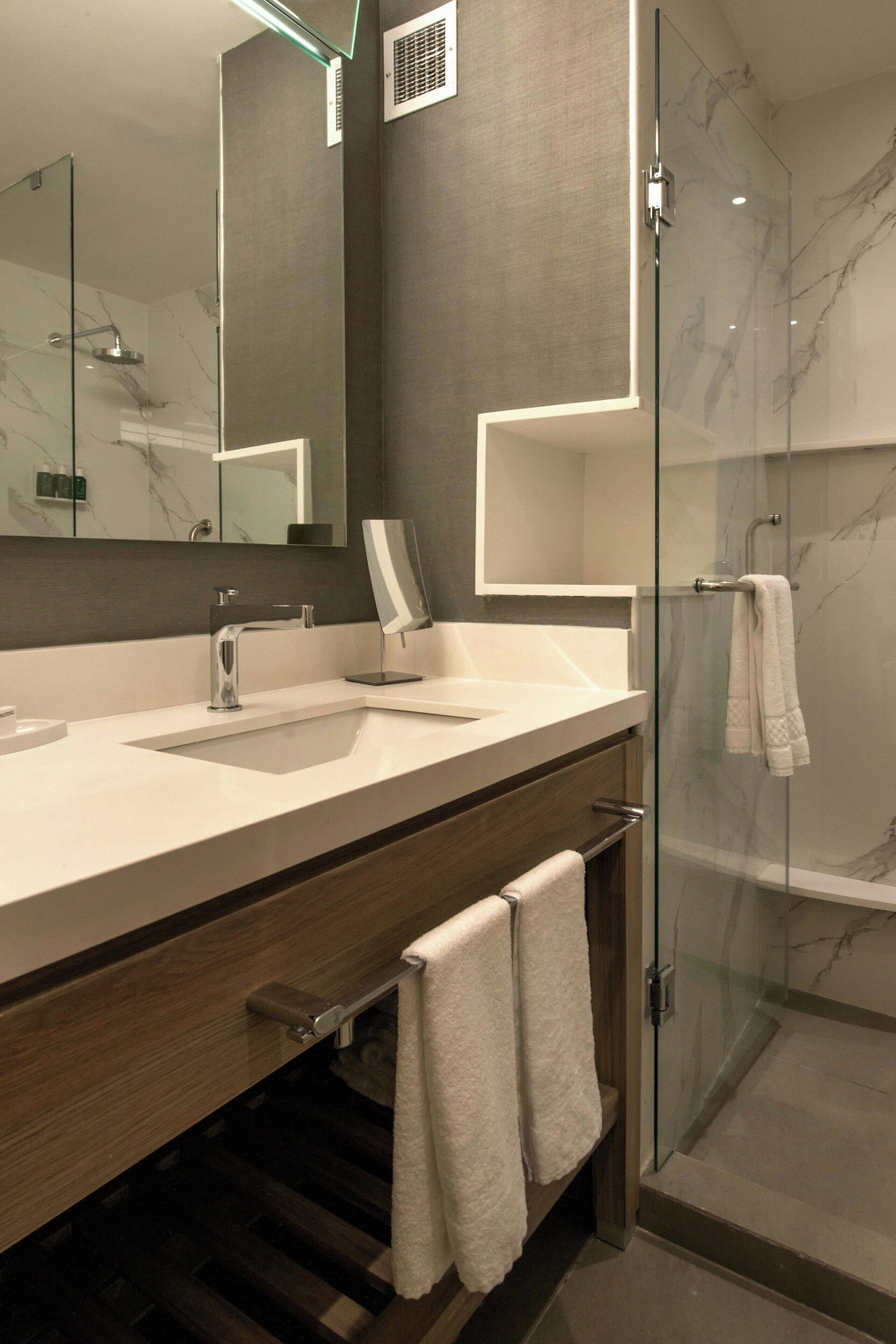 shower, rainfall showerhead, hair dryer, towels