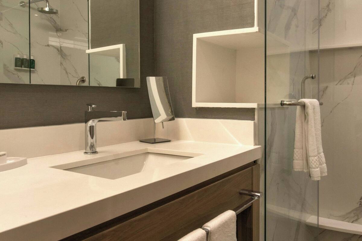 shower, rainfall showerhead, hair dryer, towels