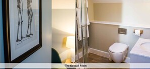 A bathroom with a toilet, a sink, and a shower area. - Crown & Punchbowl (Cambridge)