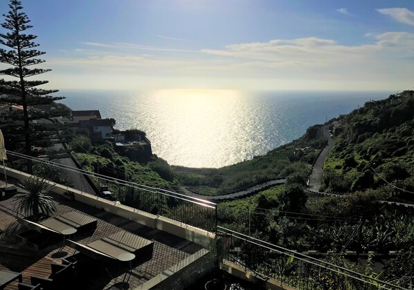 A terrace with outdoor seating overlooking a coastal landscape. - Hotel do Campo (Ribeira Brava)