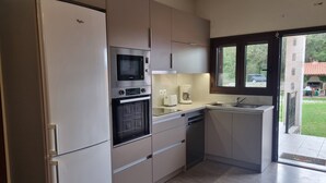 A modern kitchen with a built-in oven, microwave, and coffee maker. - Modern Countryside Villa with Private pool, spectacular view, peaceful location (Πρινές)