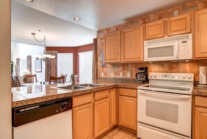 Comfort Condo, Partial Lake View | Private kitchen | Full-size fridge, microwave, oven, stovetop