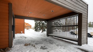 A covered outdoor area with a wooden structure, a metal gate, and a snow-covered ground. - Cedars Lodge Condos by CRMR (Frisco)